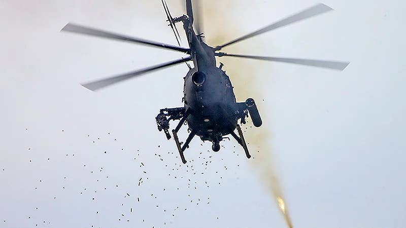 An AH-6-configured Little Bird belonging to the 160th is seen here firing a rocket and multiple types of guns. <em>U.S. Army</em>