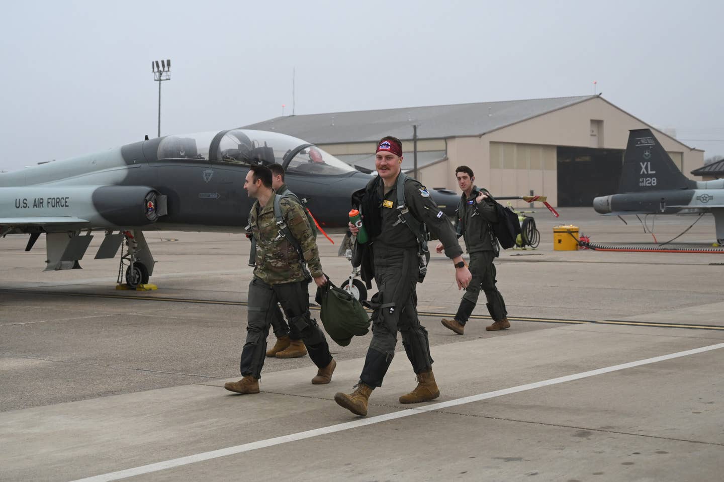 Multiple U.S. Air Force pilots walk to their respective T-38’s on the flight line at Laughlin Air Force Base, Texas on Feb. 2, 2022. (U.S. Air Force photo by Airman Kailee Reynolds)
