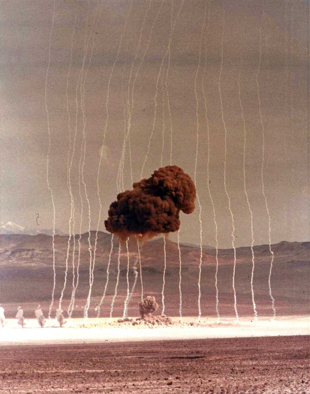 Shot Able, an airdropped device, was detonated 793 feet over Area 5 of Frenchman Flat on April 1, 1952, as part of Operation Tumbler-Snapper Able. Note the white smoke trails pictured behind the blast. <em>atomicarchive.com</em>
