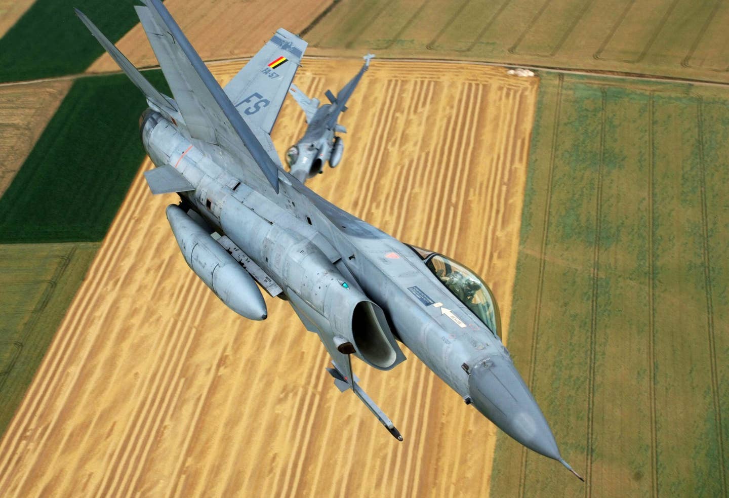 Two Belgian Air Force F-16s formate for the camera. <em>GERARD GAUDIN/AFP via Getty Images</em>