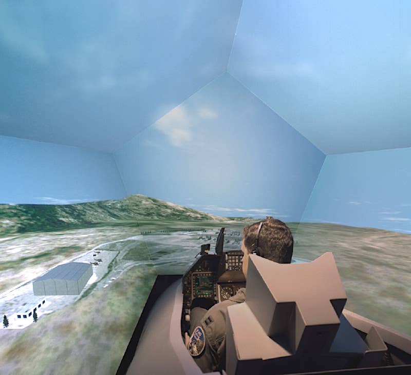 A pilot sits inside an F-16 simulator. <em>CAE</em>