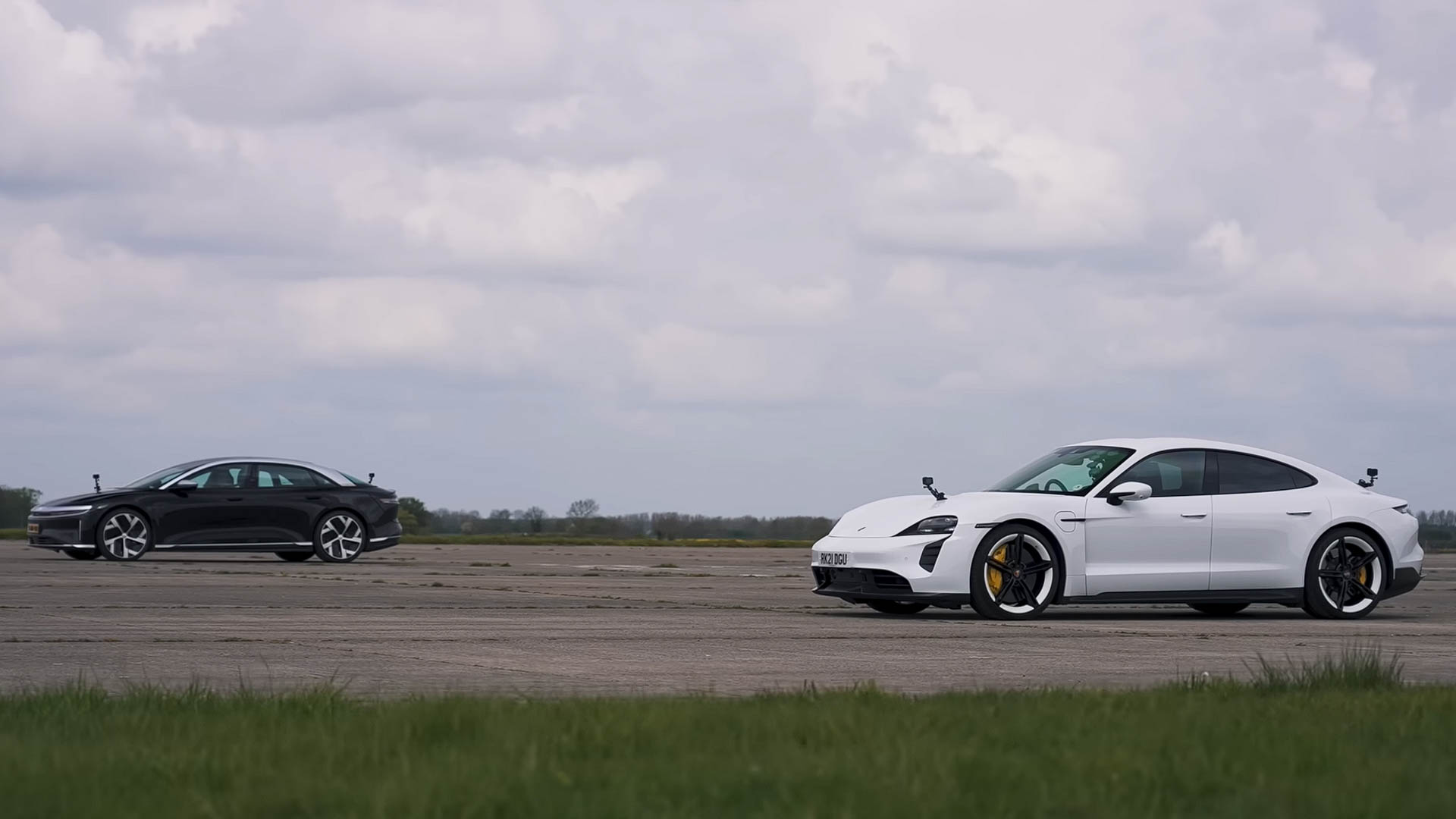 Lucid Air and Porsche Taycan parked for a performance comparison, highlighting sleek EV design and stance