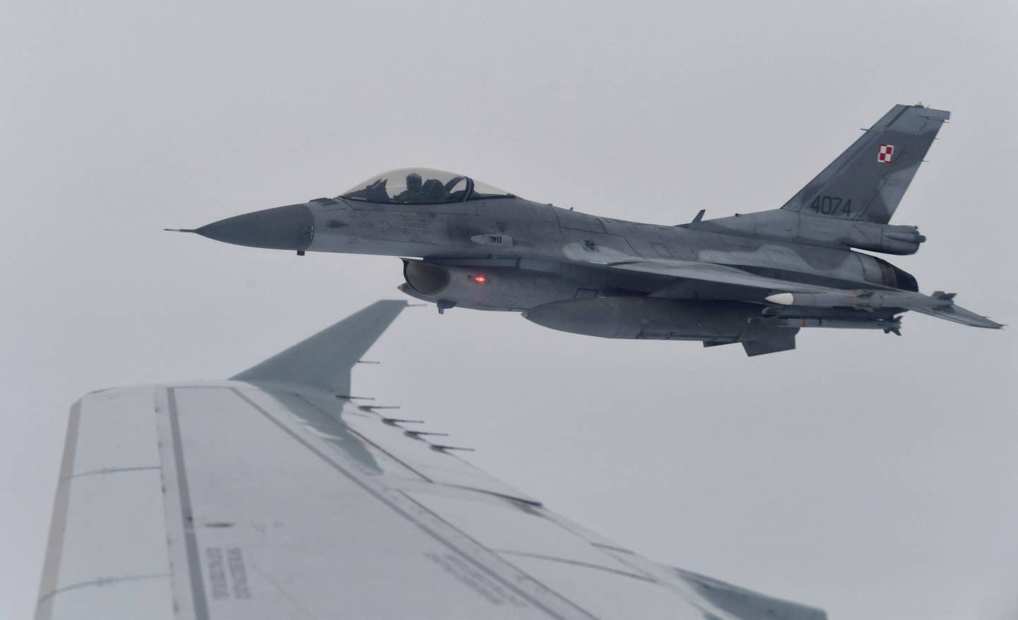 A Polish Air Force F-16C during a NATO Baltic Air Policing drill simulating the interception of a civilian flight near Siauliai Airport in Lithuania, in 2020. <em>Photo by JOHN THYS/AFP via Getty Images</em>