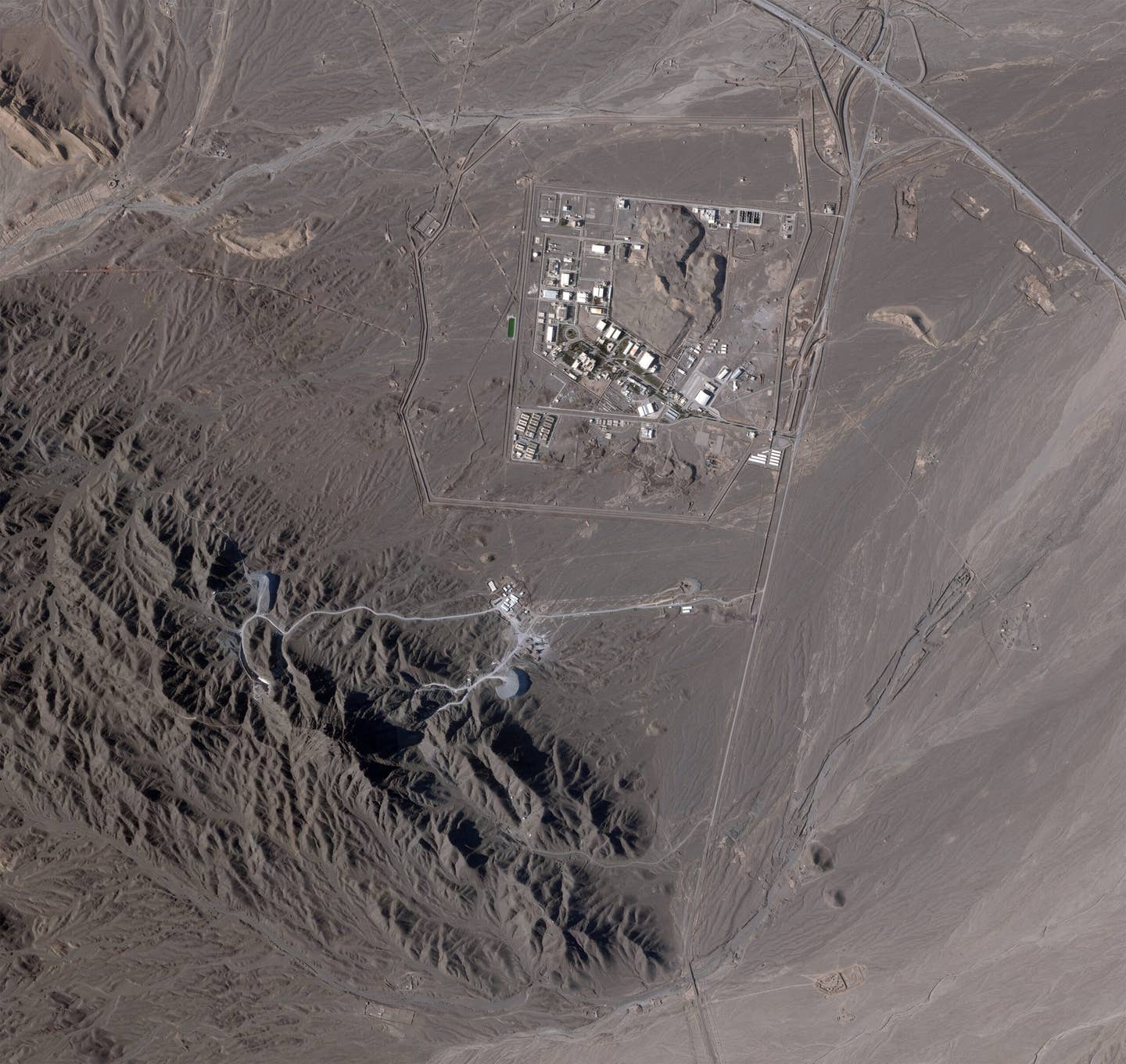 A satellite image taken on April 14, 2023, showing the facilities at Natanz, including the tunnel entrances to the south. Work on the tunnels is visibly underway, but the facility does not look close to being finished. <em>PHOTO © 2023 PLANET LABS INC. ALL RIGHTS RESERVED. REPRINTED BY PERMISSION</em>