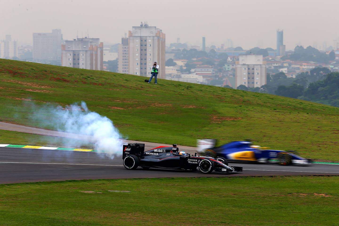 <em>Smoke billows from the car of Fernando Alonso of Spain and McLaren Honda as he stops on the track during practice for the Grand Prix of Brazil on November 13, 2015. (Photo by Clive Mason/Getty Images)</em>