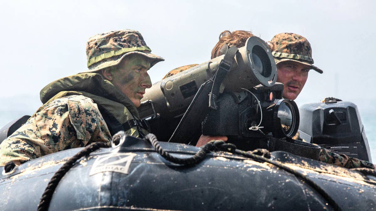 Marines in a rubber raft with a Javelin anti-tank missile launcher. <em>USMC</em>