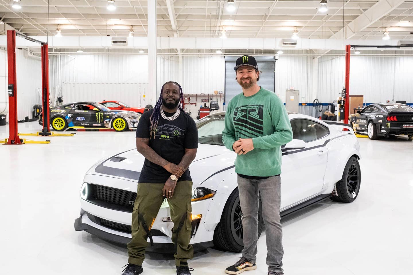 <em>T-Pain with Vaughn Gittin Jr. <a href="https://www.rtrvehicles.com/blogs/news/t-pain-rtr-spec-2-widebody" target="_blank" rel="noreferrer noopener">after picking up his new RTR Mustang</a>, which is set up for drifting with a "Fun-Haver" steering angle kit and a hydraulic handbrake.</em>
