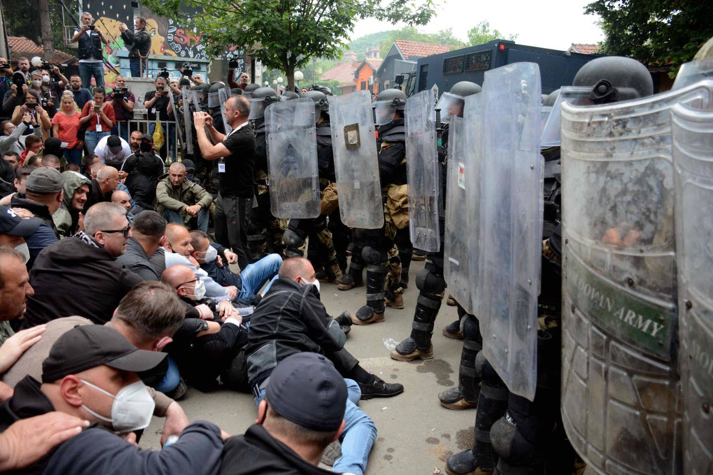 Serbs from Kosovo face riot police during their gathering to demand the removal of recently elected Albanian mayors outside the municipal building in Zvecan, northern Kosovo on May 29, 2023. <em>Photo by -STR/AFP via Getty Images</em>