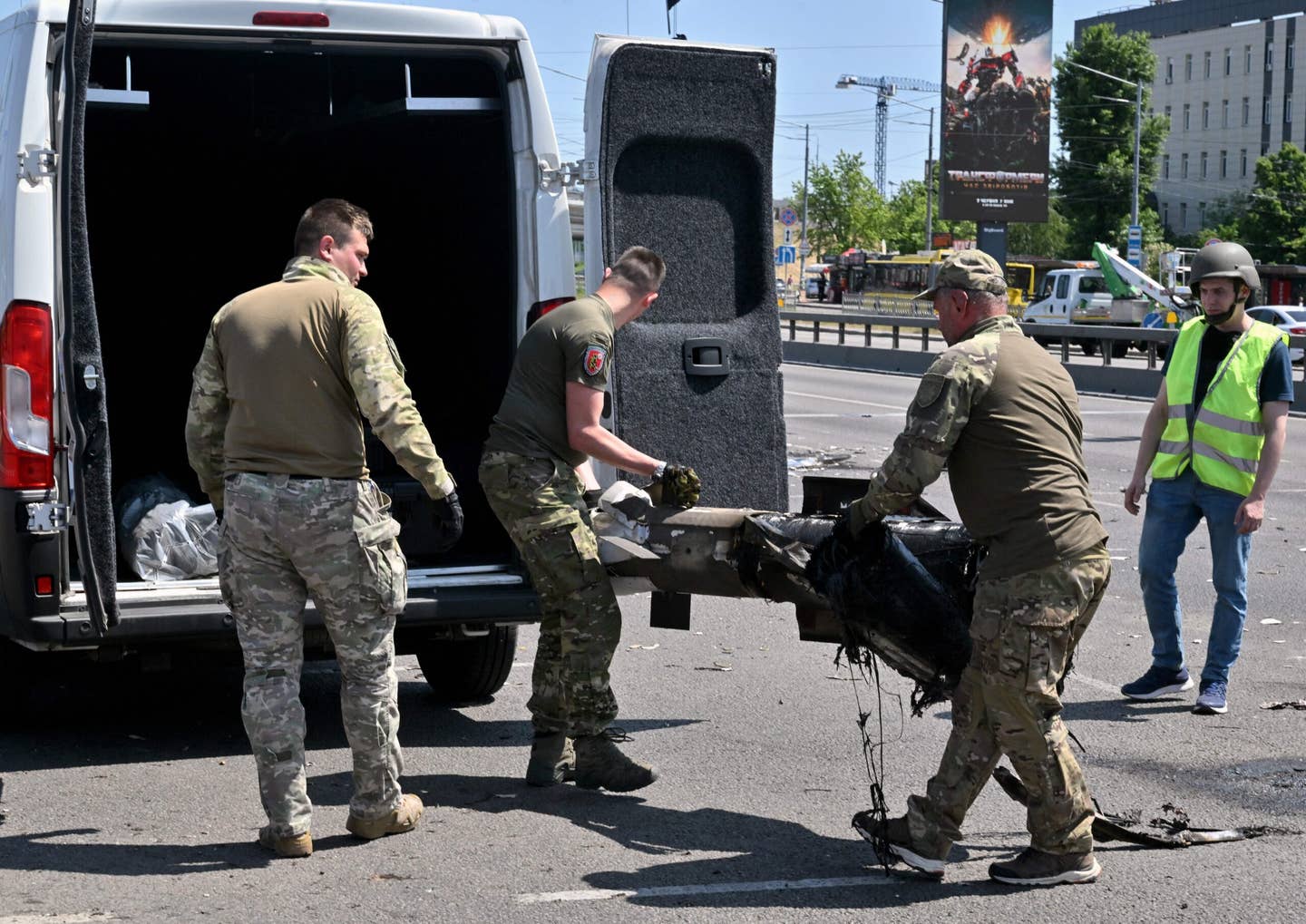 Police experts load fragments of a missile into a car after Russia fired a barrage of missiles for the second time in 24 hours, in an unusual daytime attack on the Ukrainian capital following overnight strikes on May 29, 2023. (Photo by SERGEI SUPINSKY/AFP via Getty Images)