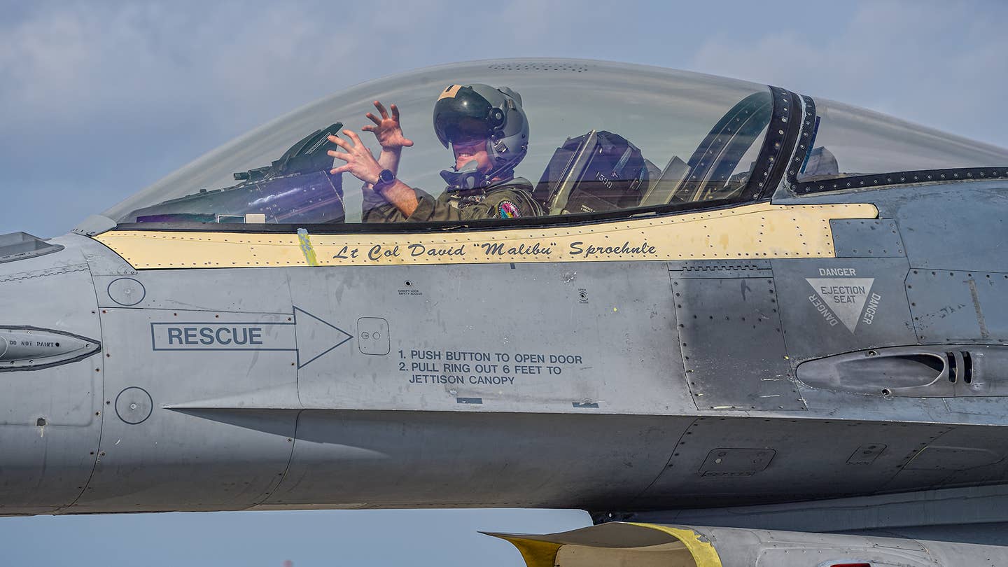 A 93rd Fighter Squadron "Florida Makos" pilot gives the squadron hand sign of the jaws of the Mako shark. <em>Jamie Hunter</em>
