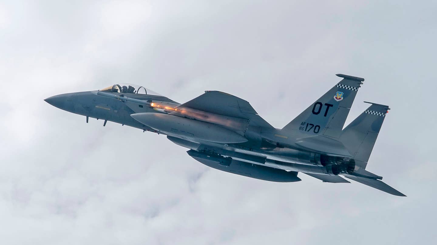 An F-15C fires an AIM-120 AMRAAM during testing. <em>USAF</em>