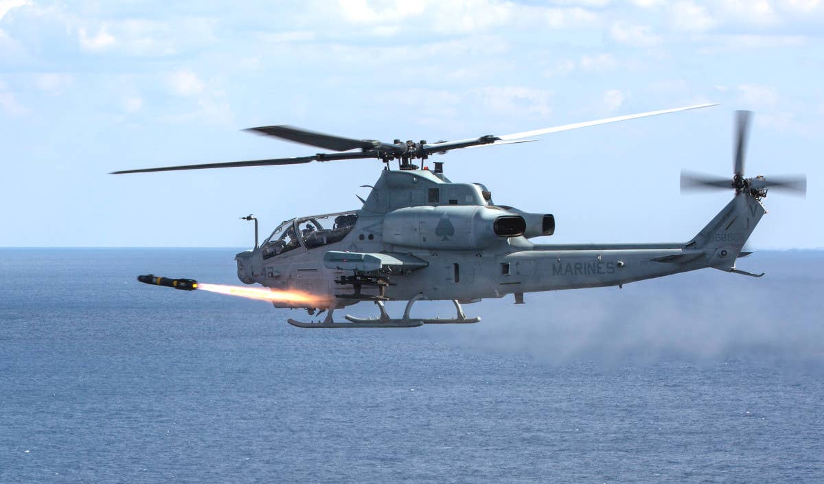 A U.S. Marine Corps AH-1Z helicopter fires a Hellfire missile during training. <em>USMC</em>