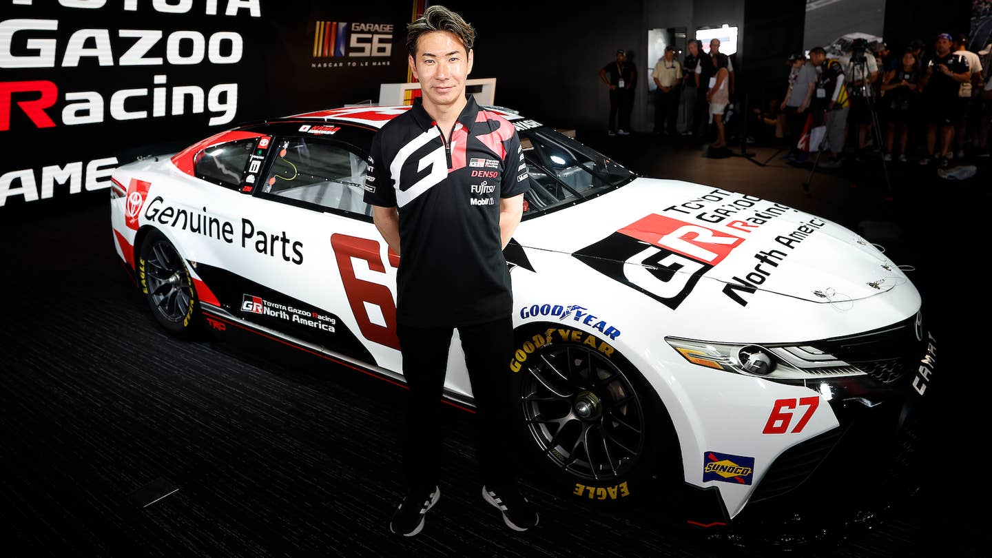 Kamui Kobayashi next to his Toyota Camry NASCAR Cup Series stock car