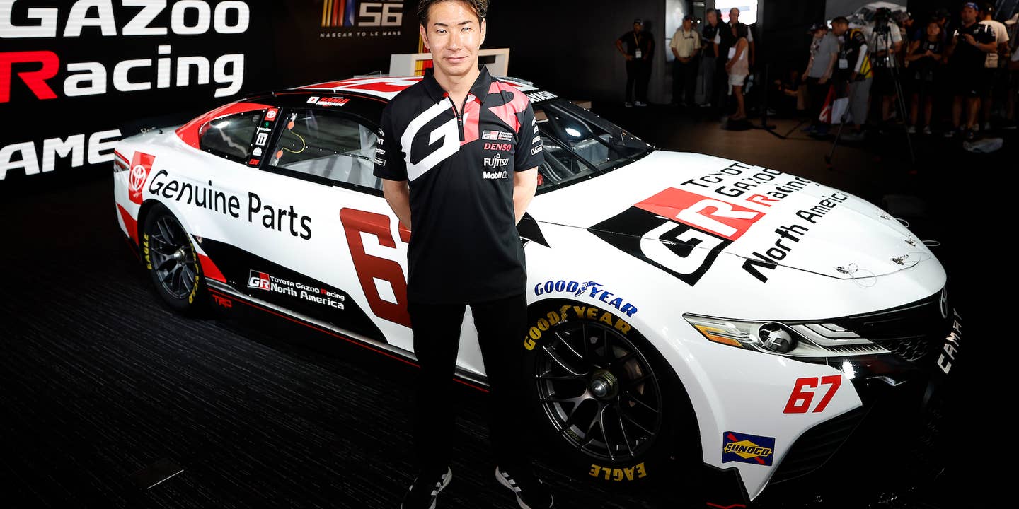 Kamui Kobayashi next to his Toyota Camry NASCAR Cup Series stock car