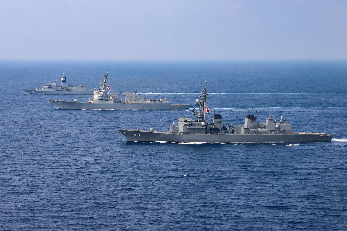 The destroyer USS <em>Momsen</em> (DDG-92), the Australian <em>Meko</em> class frigate HMAS <em>Arunta</em> (FFH-151), and the Japanese destroyer JS <em>Yuudachi</em> (DD-103) transit the South China Sea during a trilateral training event in 2022. <em>U.S. Navy photo by Naval Air Crewman (Helicopter) 1st Class Justin Sherman</em>