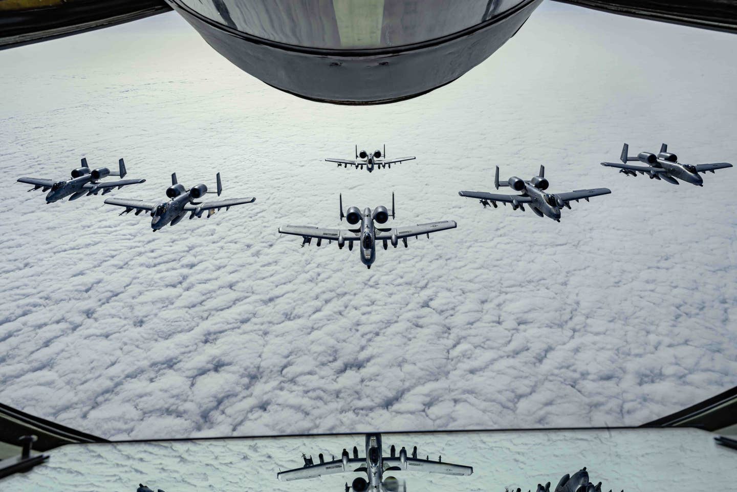 A U.S. Air Force A-10 Thunderbolt II aircraft assigned to the 127th Wing, Michigan National Guard, fly in formation behind a KC-135 Stratotanker assigned to the 128th Air Refueling Wing, Wisconsin National Guard, during the air bridge on the way to exercise Air Defender 2023 (AD23), June 5, 2023. <em>U.S. Air National Guard photo by Master Sgt. Lauren Kmiec</em>