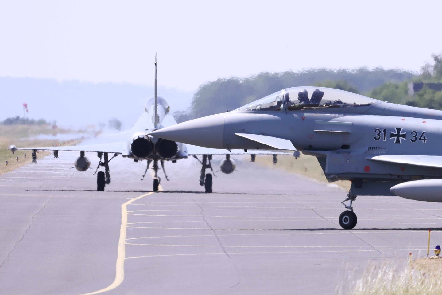 13 June 2023, North Rhine-Westphalia, Nörvenich: German Air Force Eurofighter fighter jets taxi to the runway at the Oswald Boelcke Barracks air base as part of the "Air Defender 2023" military exercise. <em>Photo by David Young/picture alliance via Getty Images</em>