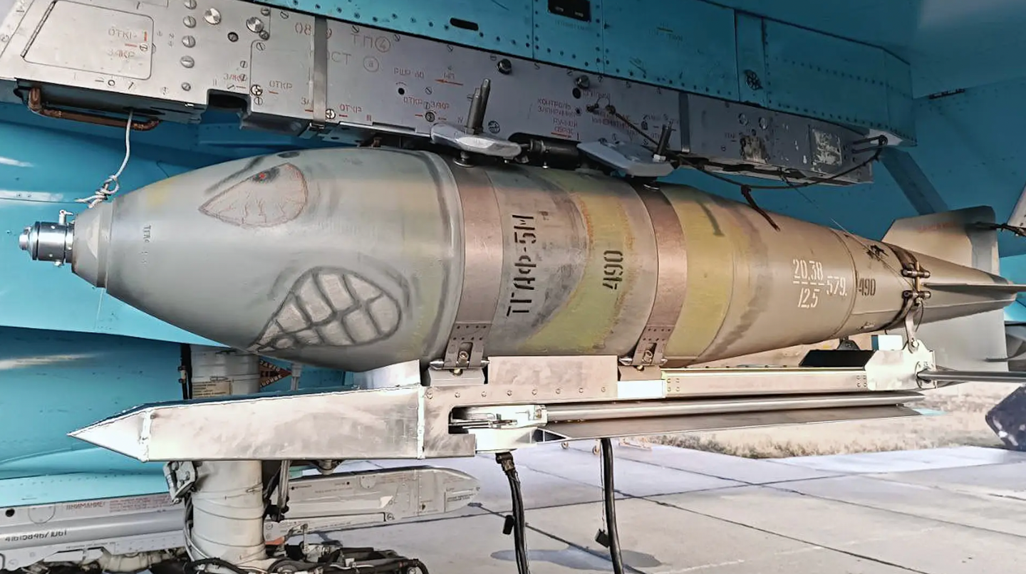 A Russian FAB-500M-62 bomb with a kit attached that features pop-out wings, loaded onto a Su-34 Fullback combat jet. This extended-range weapon does not appear to feature any guidance system.&nbsp;<em>via Telegram</em>