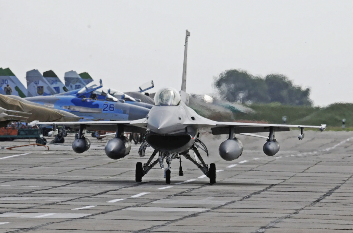 An Alabama Air National Guard F-16C taxies past Ukrainian Su-27 and MiG-29 fighter jets, on the ramp at Mirgorod Air Base, Ukraine, during an exercise in 2011.&nbsp;<em>U.S. Air Force</em>