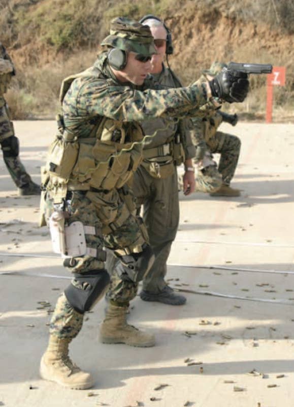 A member of Marine Corps Special Operations Command, Detachment One, fires an M1911 variant. <em>USMC</em>