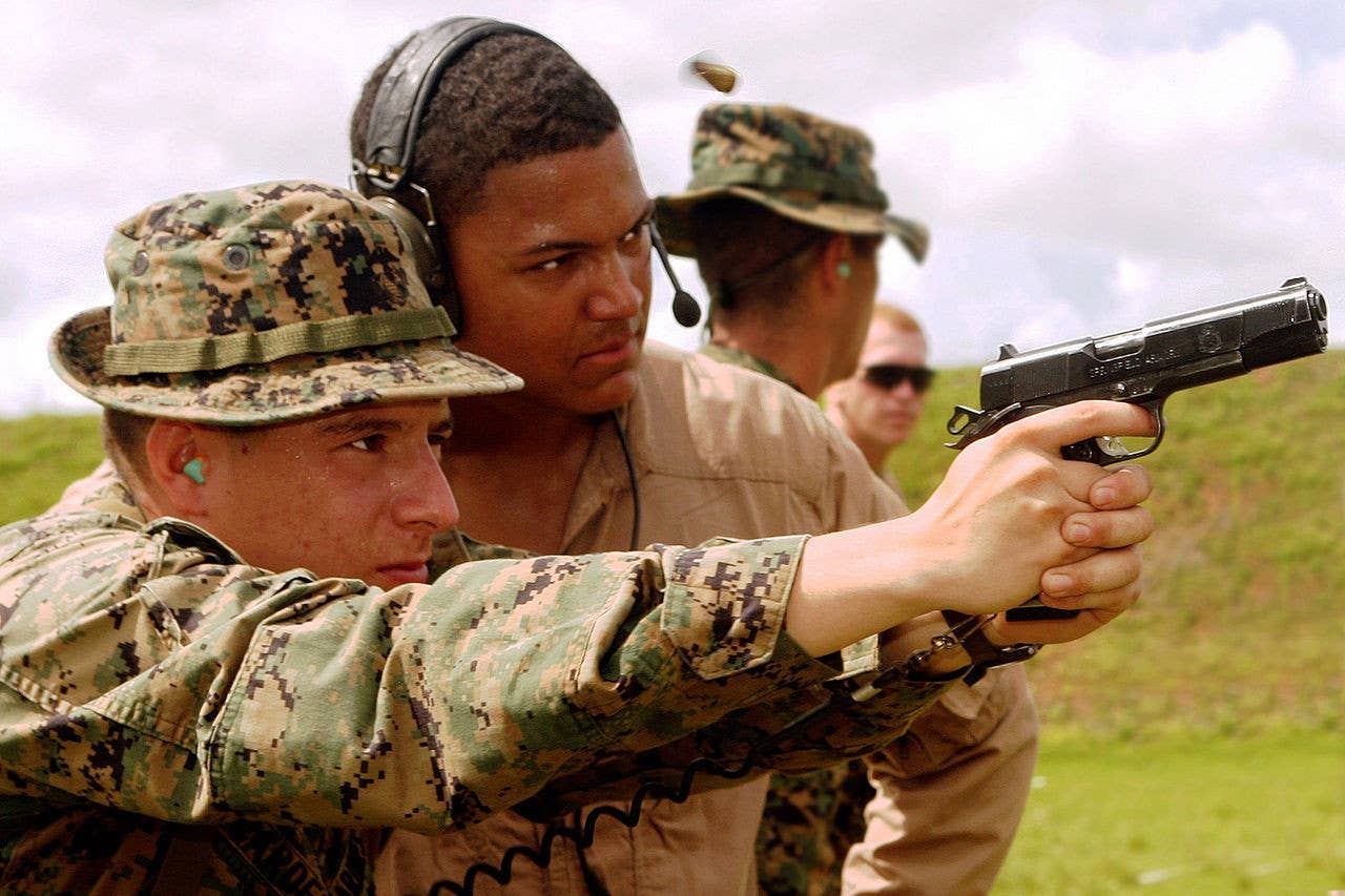 A Marine fires a MEU(SOC) pistol during training. <em>USMC</em>