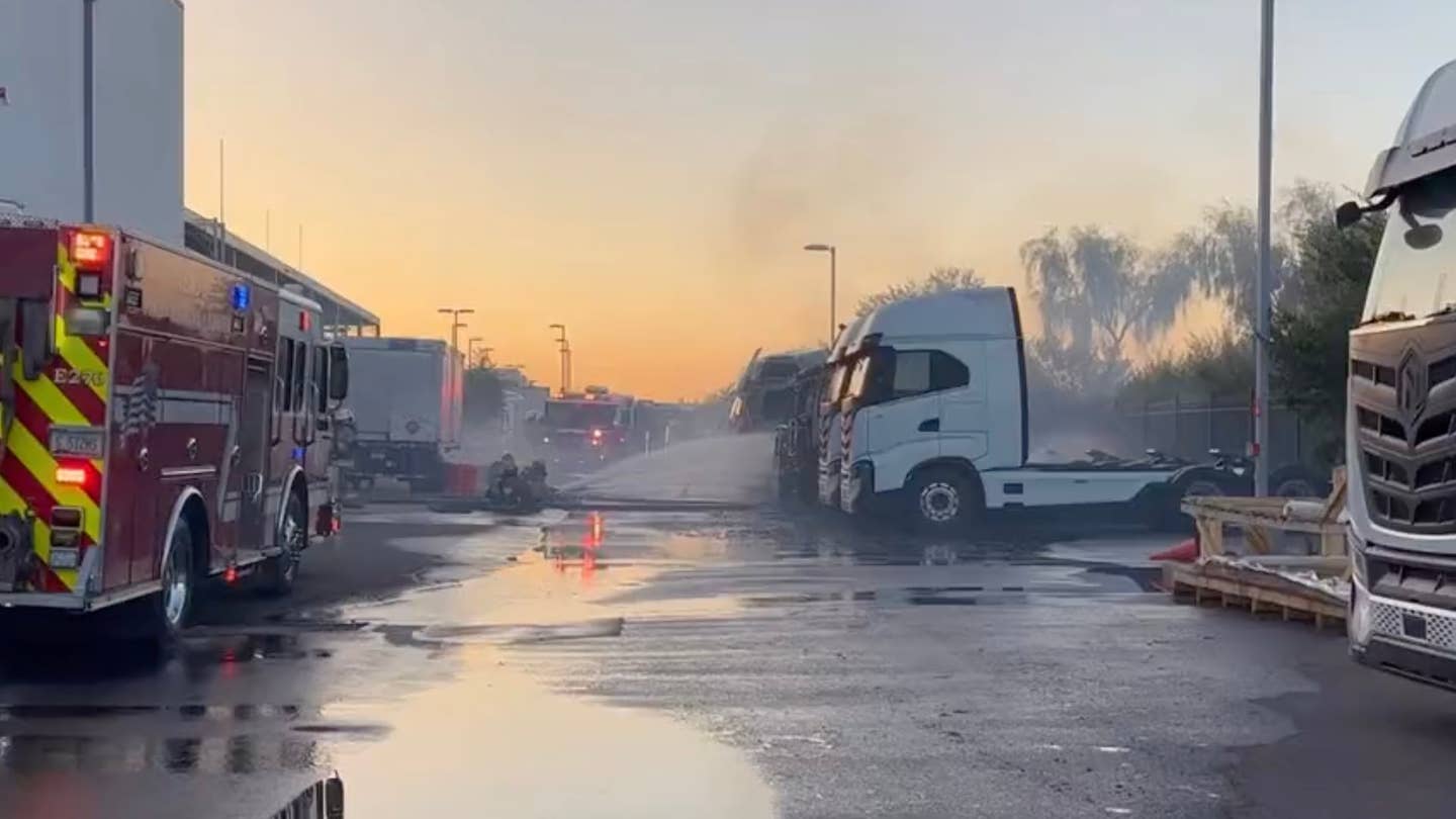 Firefighters douse a Nikola electric truck in water after a battery fire