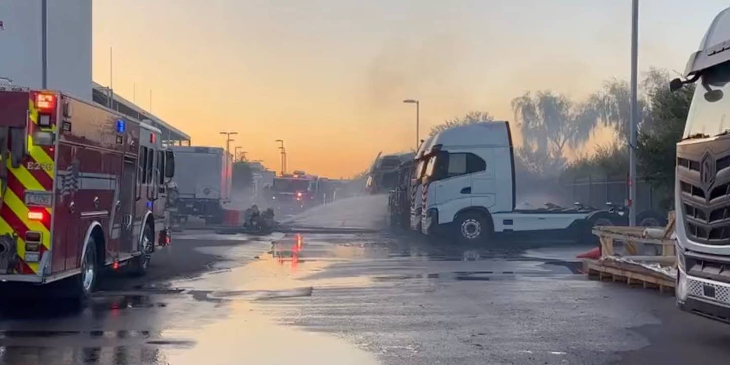 Firefighters douse a Nikola electric truck in water after a battery fire