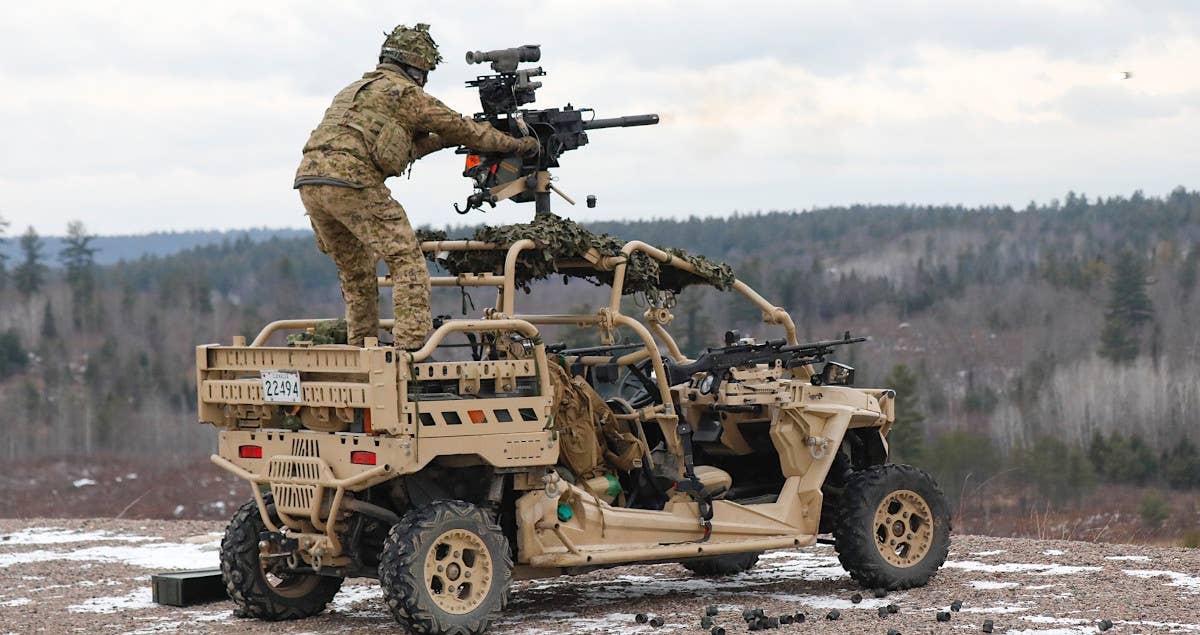 A Canadian soldier fires a C16 automatic grenade launcher mounted on an MRZR all-terrain vehicle. <em>Canadian Armed Forces</em>