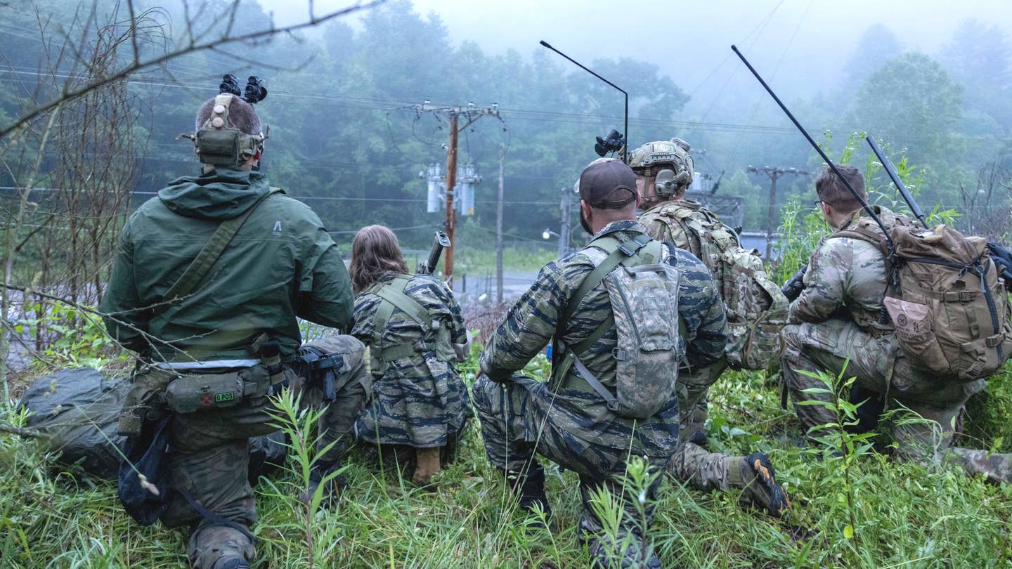 Personnel taking part in Ridge Runner 23-01 in a position along a road. <em>Army National Guard</em>
