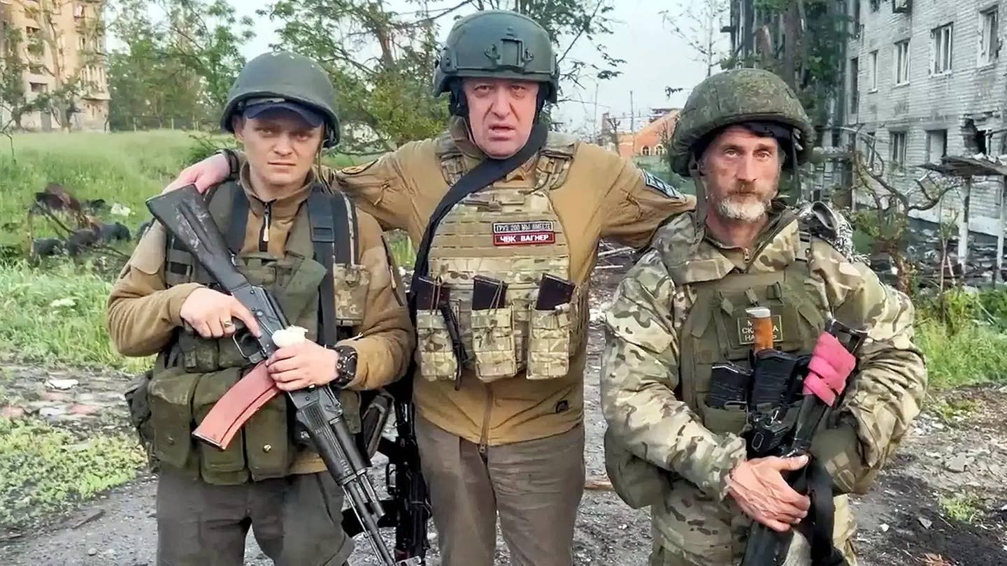 Yevgeny Prigozhin, in the center, and two Wagner members in Ukraine. <em>via Russian social media</em>