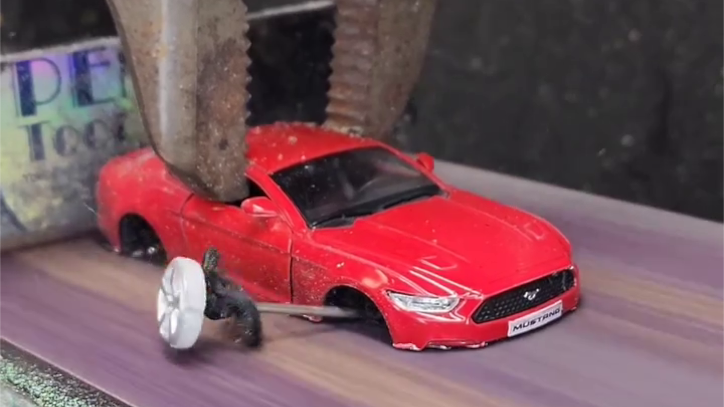 Watch a Belt Sander Slowly Erase All These Toy Cars