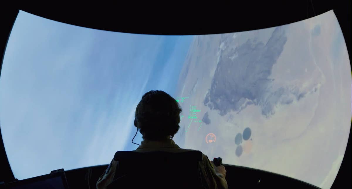 Air Force Test Pilot School's chief test pilot Bill "Evil" Gray inside a simulator. <em>USAF capture</em>