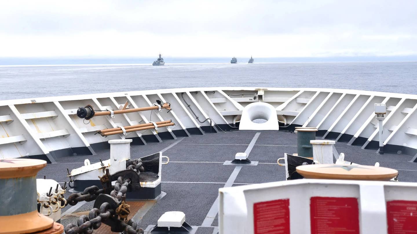 A trio of Chinese warships are seen from the deck of a US Coast Guard ship shadowing them near Alaska's Aleutian Islands as they headed north toward the Arctic Region in 2021. <em>USCG</em>