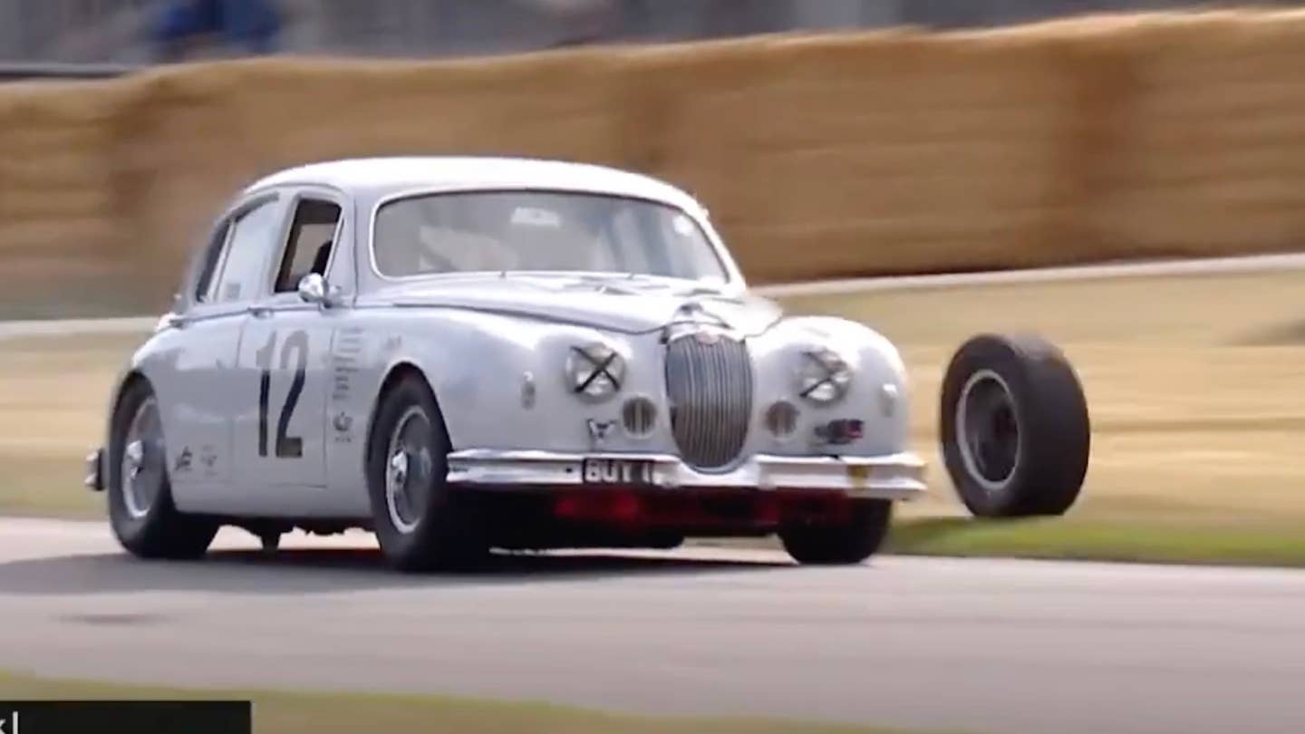 A 1959 Jaguar Mark 1 loses its left rear wheel at the 2023 Goodwood Hillclimb