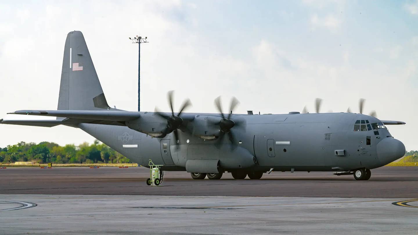 A US Air Force C-130J Hercules cargo aircraft with its serial number, tail code, and other typical individually identifying markings removed from its tail and elsewhere along the fuselage as part of a still relatively new operations security policy. <em>USAF</em>