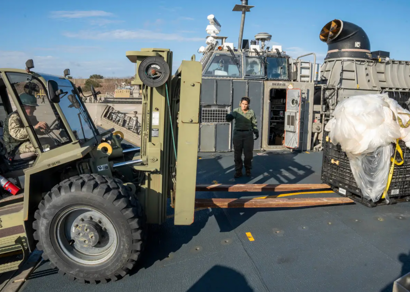 U.S. Navy personnel prepare to move portions of a Chinese surveillance balloon that were recovered off the coast of South Carolina after being shot down on February 4, 2023 and then carried ashore by a Landing Craft Air Cushion (LCAC) hovercraft.&nbsp;<em>U.S. Navy</em>
