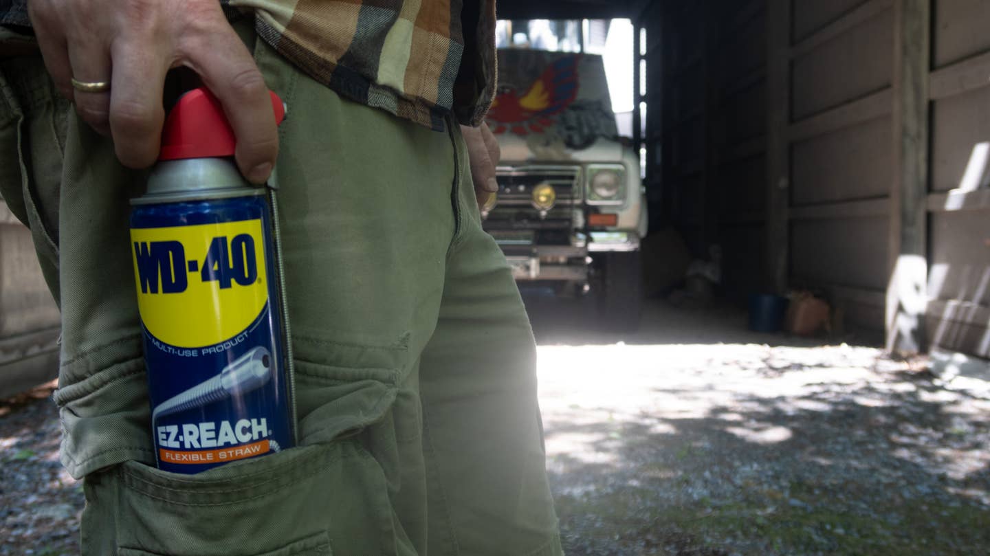 Blue and yellow can of WD-40 in the big pocket of some cargo shorts.