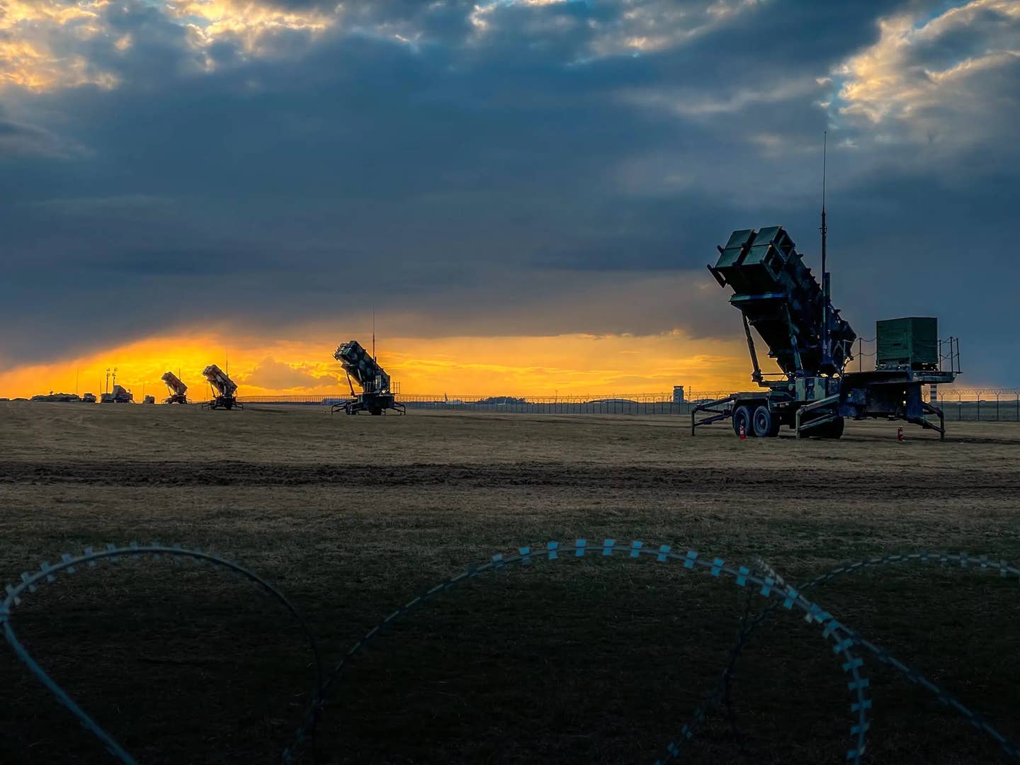 U.S. Patriot missile batteries from the 5th Battalion, 7th Air Defense Artillery Regiment stand ready at sunset in Poland on April 10, 2022. <em>U.S. Army photo by Sgt. 1st Class Christopher Smith</em>