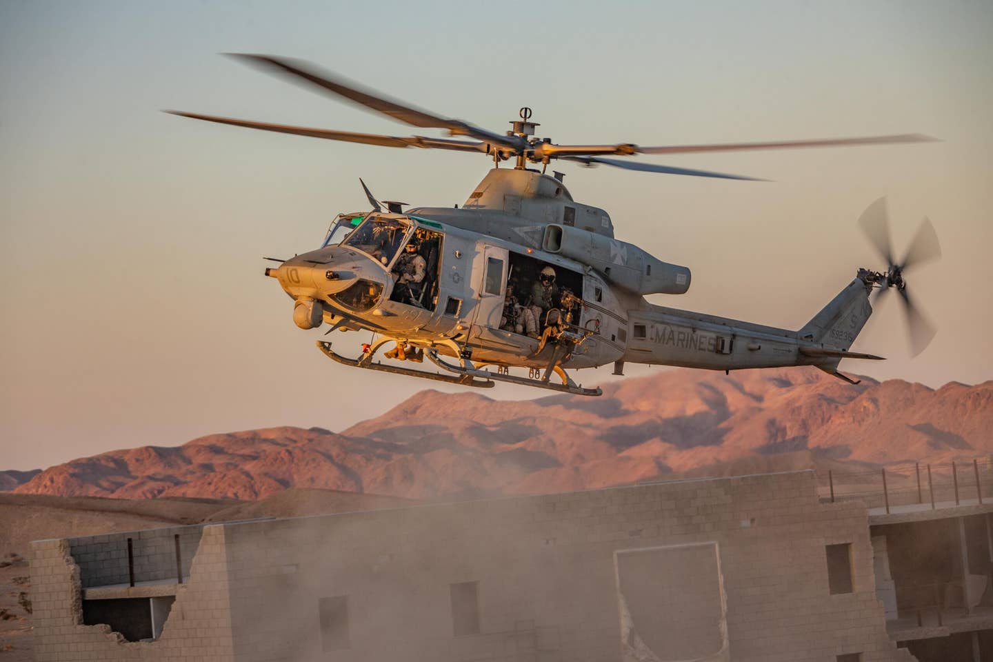 A U.S. Marine Corps UH-1Y Venom helicopter, assigned to Marine Aviation Weapons and Tactics Squadron One, descends in an extraction exercise, at Marine Corps Air Ground Combat Center Twentynine Palms, California, April 14, 2023. <em>USMC</em>