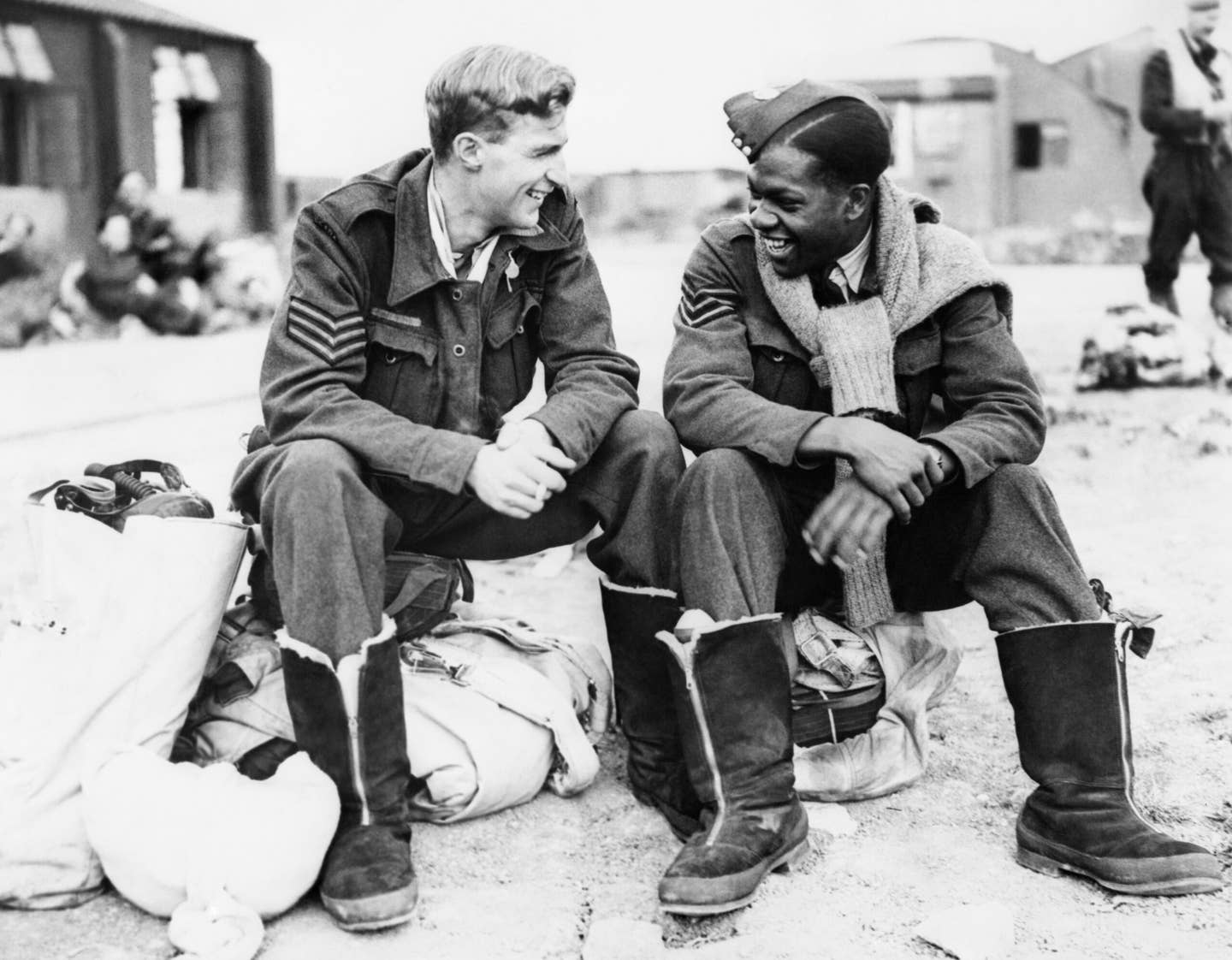 Two RAF Bomber Command aircrew, Sergeant J. Dickinson from Canada and Sergeant F. Gilkes from Trinidad, waiting to board their aircraft for a raid on Hamburg in 1943. <em>Photo by Press Agency photographer/Imperial War Museums via Getty Images</em>