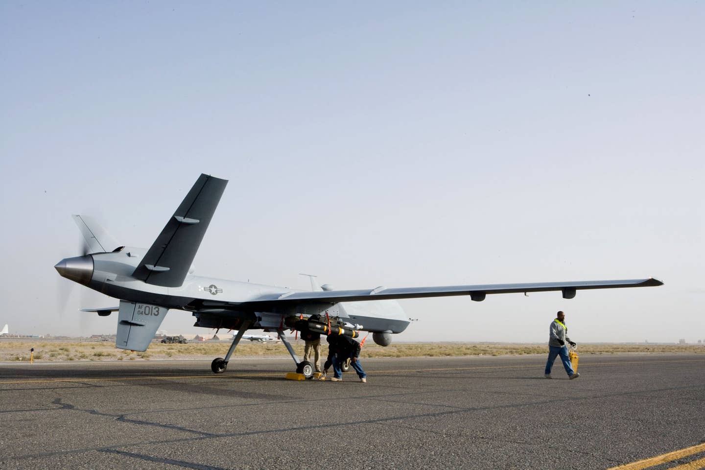 Aircrews perform a preflight check on an MQ-9 Reaper in Afghanistan. <em>U.S. Air Force</em>
