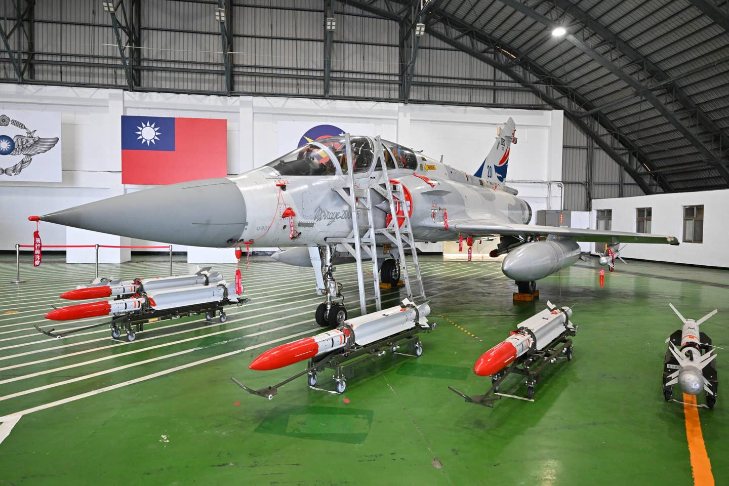 One of the ROCAF’s two-seat Mirage 2000-5DI fighters displayed in a hangar behind an array of MICA RF and Magic 2 air-to-air missiles.