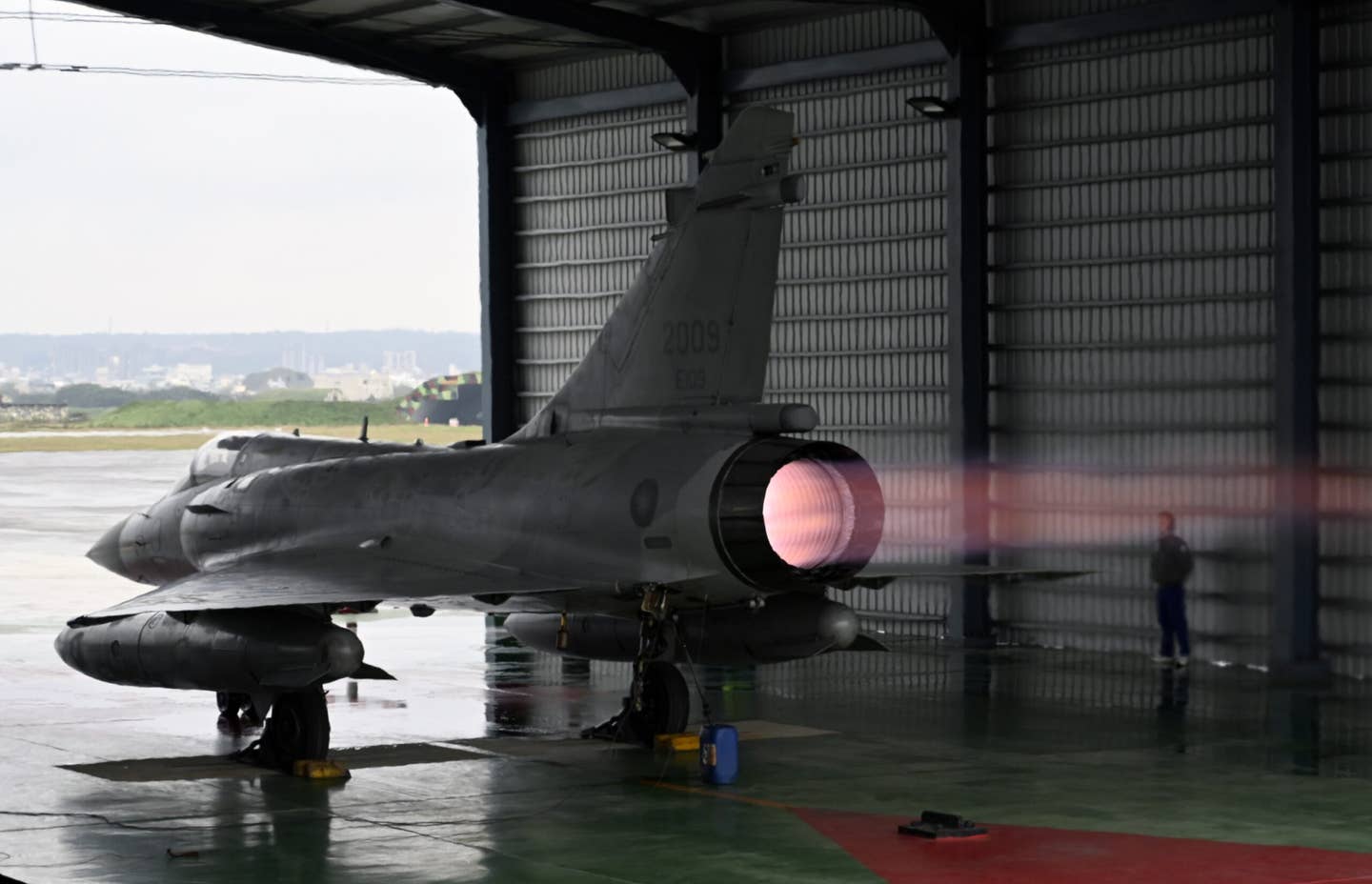 A ROCAF technician stands next to a Mirage 2000-5 jet in a hangar during a full-power engine test during an annual exercise at Hsinchu Air Base on January 16, 2019. <em>SAM YEH/AFP via Getty Images</em>