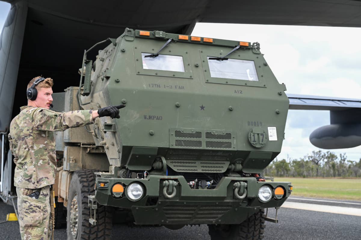A US Army HIMARS launcher rolls out the rear of a US Air Force MC-130J Commando II during Talisman Sabre 23. <em>USAF</em>