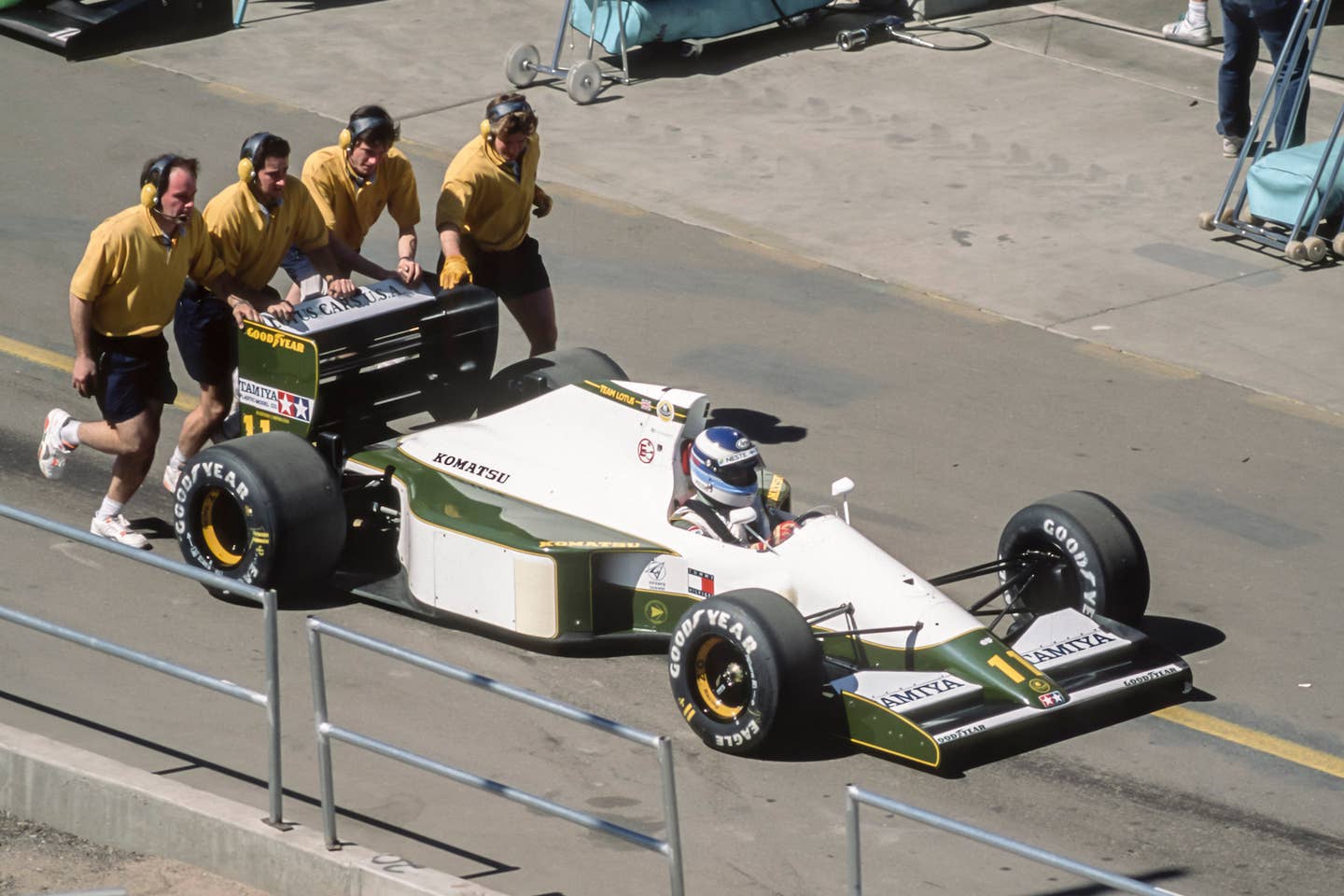 Team Lotus personnel push Mika Hakkinen's Lotus 102B at the 1991 United States Grand Prix in Arizona