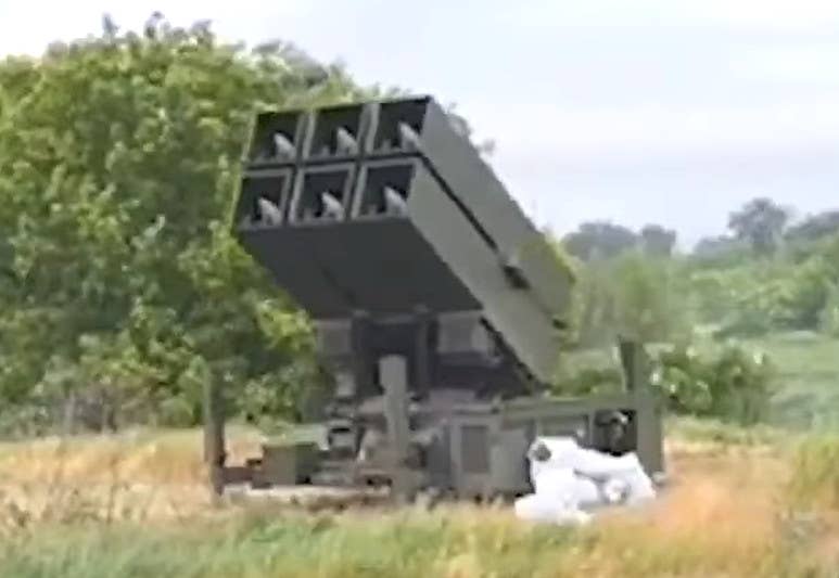 A screen capture from the video released this past weekend showing the NASAMS launcher just before it fires the missile. The missiles loaded in the launch canisters have very pointed-looking noses, unlike those on the AIM-9X or IRIS-T. <em>Ukrainian Air Force capture</em>