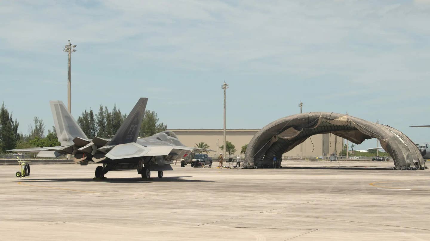The Air Force says the "prototype portable camouflage, concealment, and deception hangar" seen here at Homestead Air Reserve Base in Florida during an exercise in 2023 is one of the ways it is working to obscure its activities from enemy forces during future conflicts. <em>USAF</em>