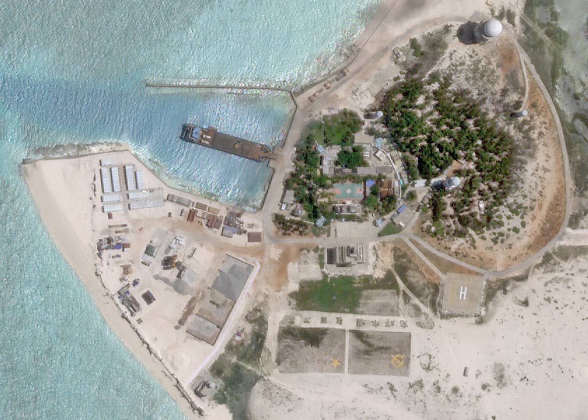 Infrastructure on the island as of August 10, 2023. The construction works adjacent to the harbor are all entirely new, apparently in support of the airstrip construction. <em>PHOTO © 2023 PLANET LABS INC. ALL RIGHTS RESERVED. REPRINTED BY PERMISSION</em>