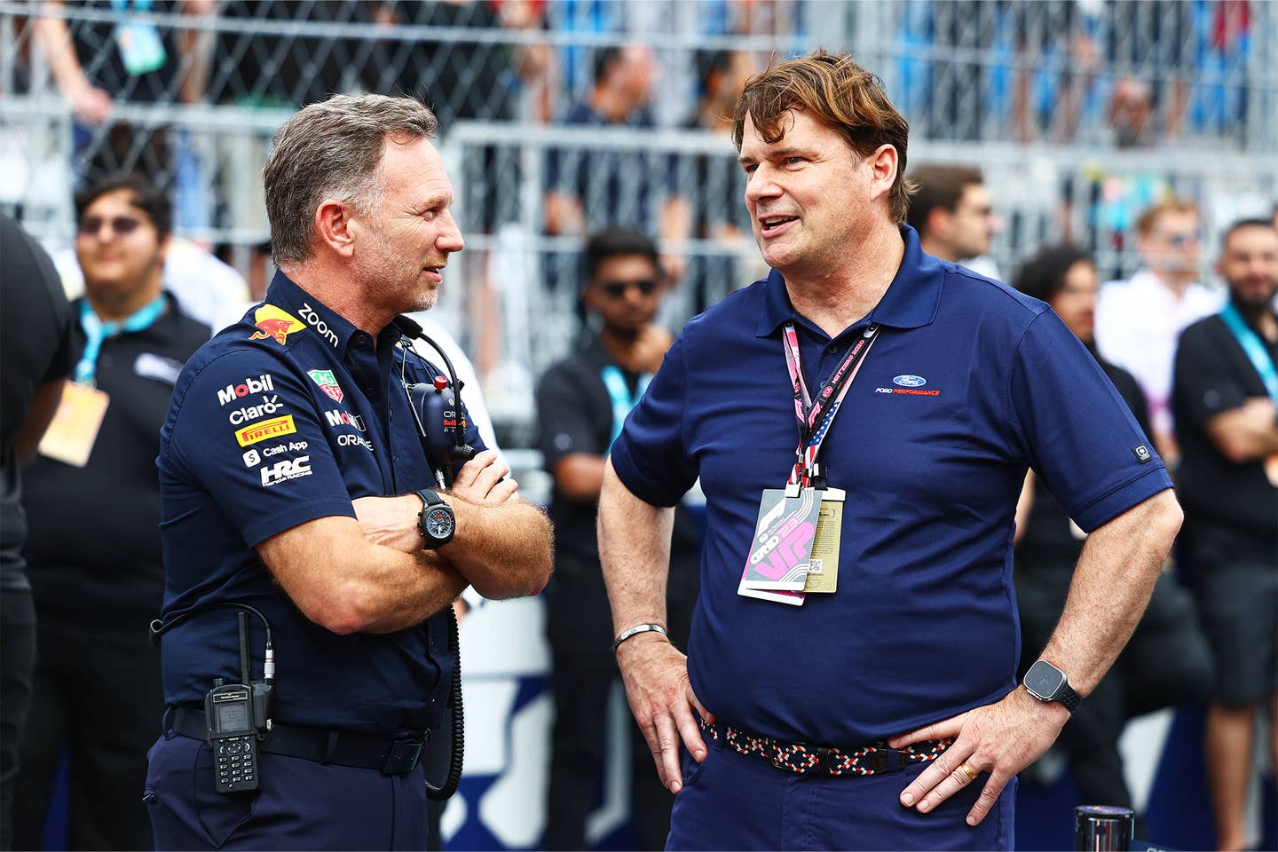 Jim Farley, at right, chats with Red Bull F1 team principal Christian Horner.