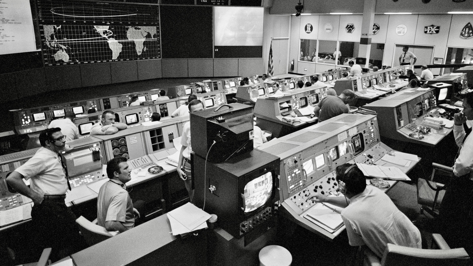 Mission Operations Control Room (MOCR) activities during Apollo 11's re-entry on July 24, 1969. NASA